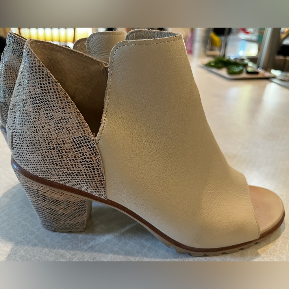 Sorel Nadia Booties. Crème with snakeskin ankle accent